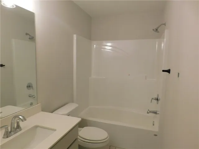 This clean and inviting bathroom offers a perfect blend of comfort and essential amenities.