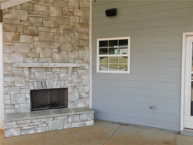 An inviting outdoor fireplace crafted from natural stone awaits to create memorable gatherings.