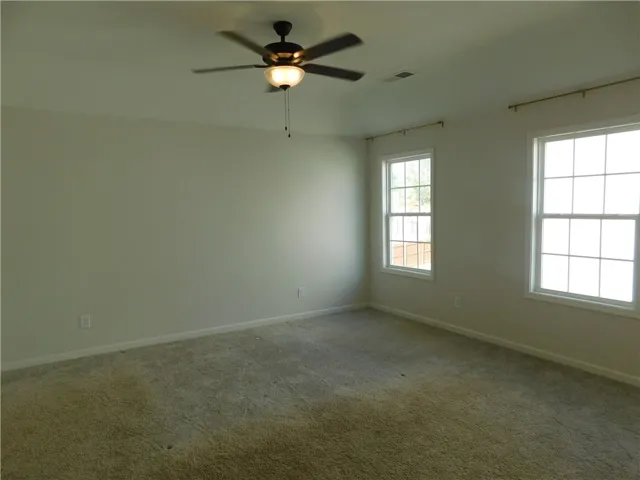 This spacious room features ample natural light and a comfortable atmosphere for rest and relaxation.