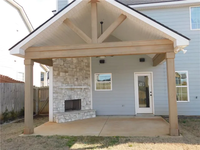 This inviting patio offers a perfect setting for outdoor relaxation with a cozy fireplace.