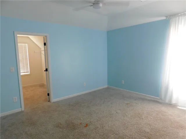 Bright and airy bedroom offering a cozy retreat with ample natural light.