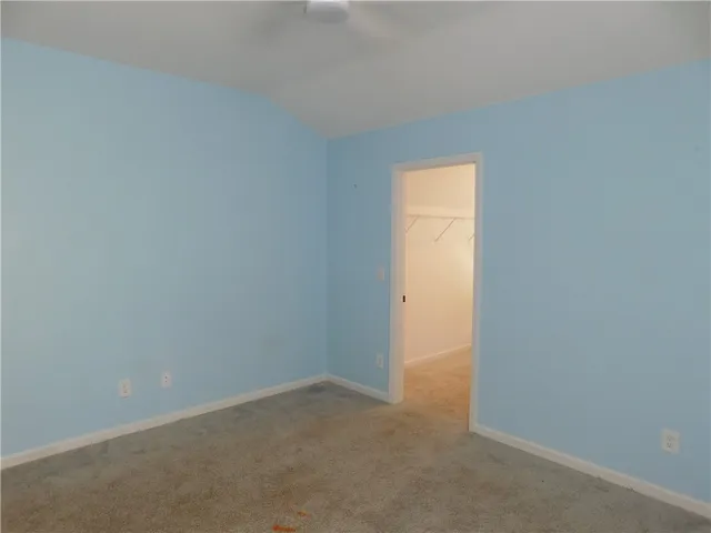 This spacious bedroom offers ample space and a convenient walk-in closet for organized living.