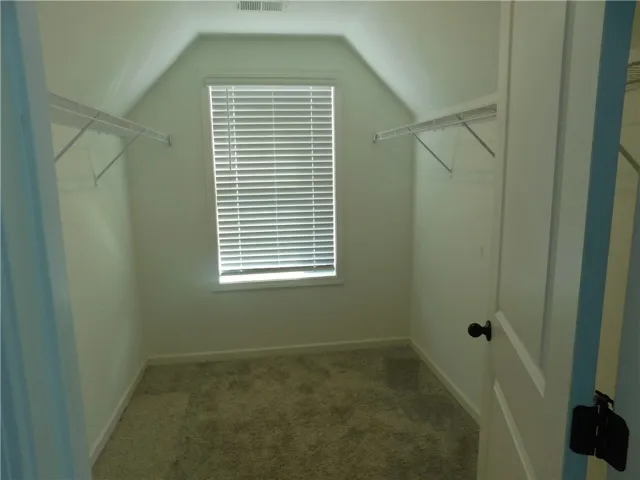 This cozy closet features practical shelving and abundant natural light.