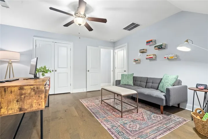 Bonus room/bedroom 4 combines generous space with sophisticated design, highlighted by wallpaper and a built-in wall system. Versatile enough for use as a bedroom, office, or rec room, it also offers an adjoining powder bath and extra closet space for added functionality.