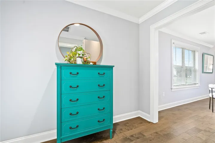 This charming vignette is nestled in the vestibule connecting the common areas to the primary suite and porch access.