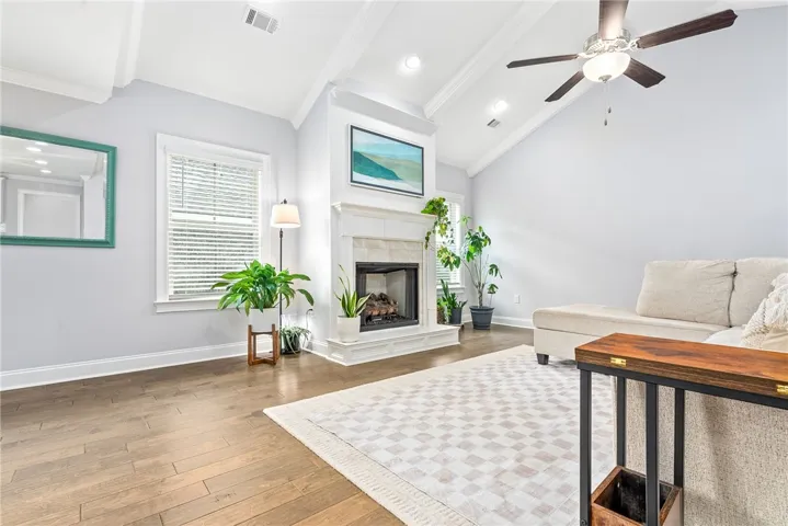 Flanked by windows, the gas fireplace anchors the room, and the hearth offers an inviting perch.