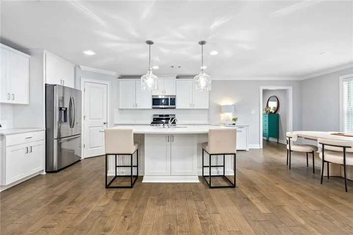 The bright, open kitchen provides plenty of space for meal prep. With bar seating at the dual-sided island and a dining area nearby, the kitchen is an ideal place to gather.