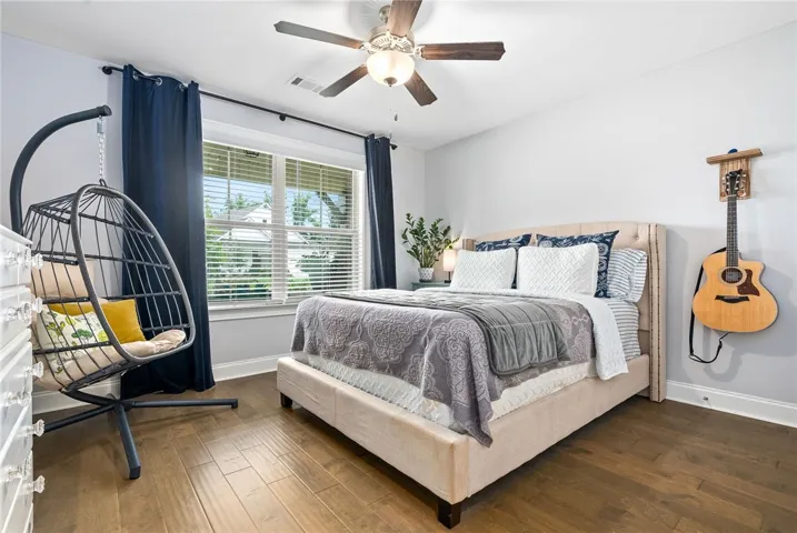 Bedroom two located at the front of the home offers wood floors, a double window, and a sizable closet.