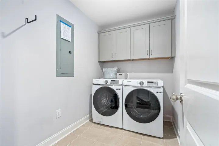 The oversized laundry has built-in cabinetry and tons of space for storage, a folding table, or even a mud bench/drop zone.