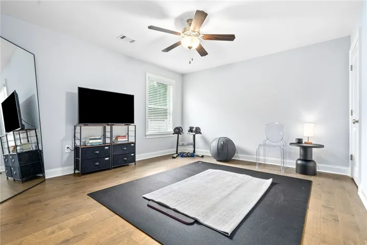 Currently serving as a workout space, bedroom 3 has the added benefit of two sizable closets and wood floors.