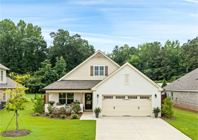 With a wide front porch, brick exterior with shake accents, and immaculate landscaping, the curb appeal of 1627 Hidden Lakes Drive is perfect!