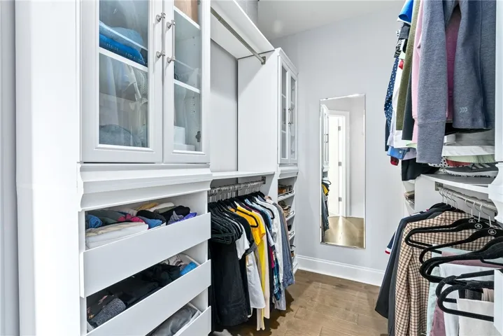 The primary closet features a custom organizational system.