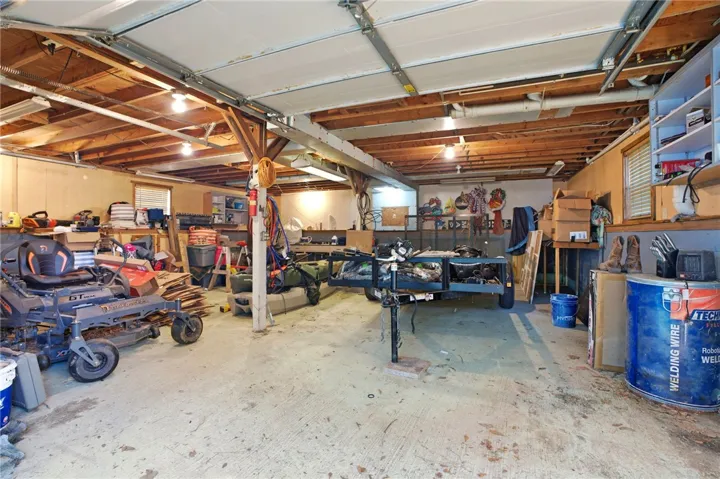 Functional garage with ample storage offers versatile utility space for various needs.