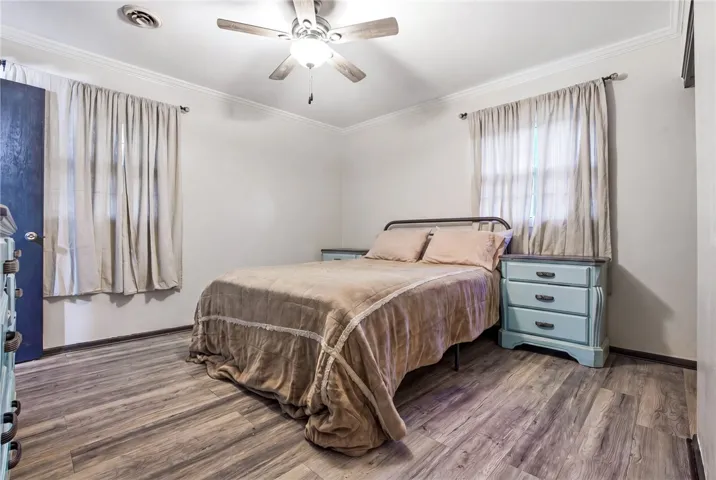 This cozy bedroom features durable flooring and ample natural light, creating a comfortable and inviting atmosphere.