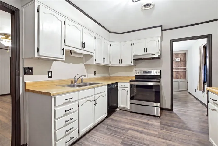 This spacious kitchen offers ample cabinet storage and a practical layout for daily living.