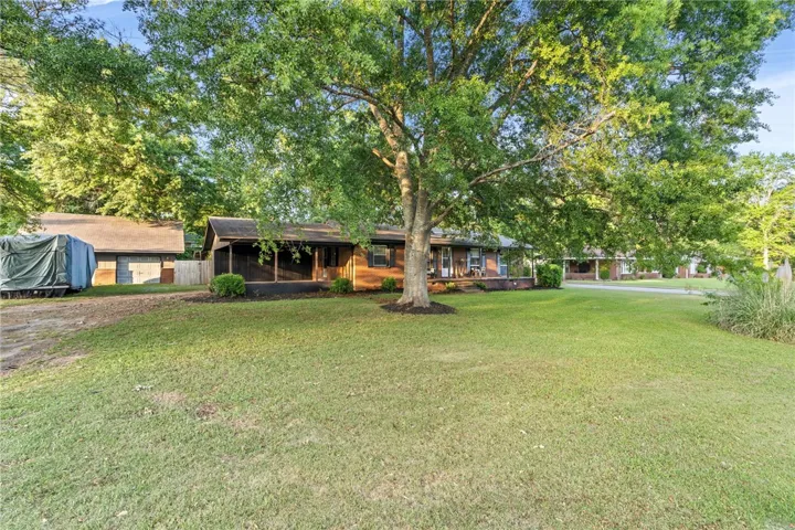 This charming home features a classic brick exterior and an inviting porch, perfect for relaxation.