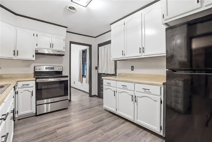 This spacious kitchen offers ample cabinetry, modern appliances, and durable flooring for everyday living.