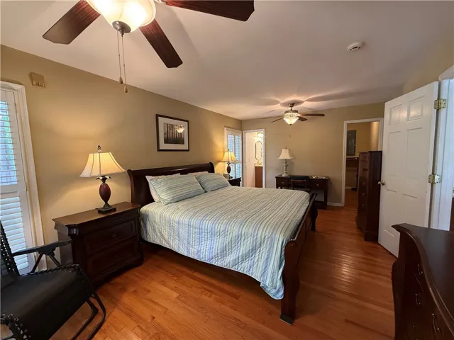 This spacious room features rich wood flooring, natural light, and offers a private and comfortable living space.