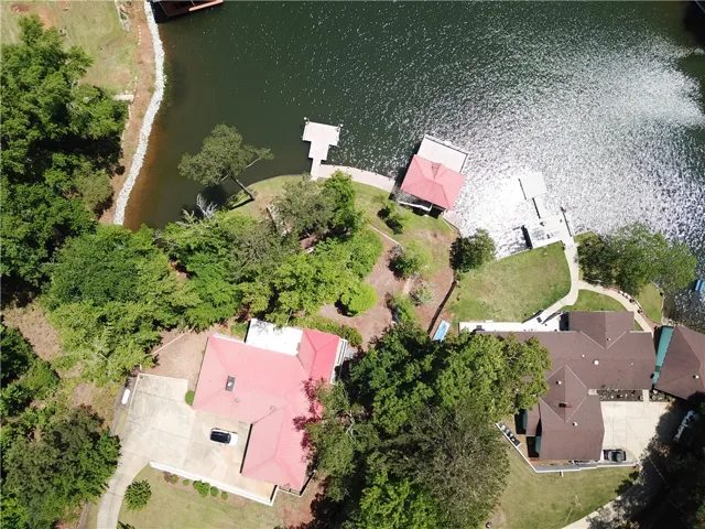 This aerial view showcases a vibrant waterfront property with private docks and lush surroundings.