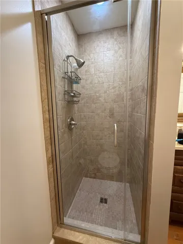 This bathroom features a sleek glass-enclosed shower with contemporary tile work.
