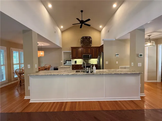 This kitchen features rich cabinetry, a functional island, and an inviting open concept design.