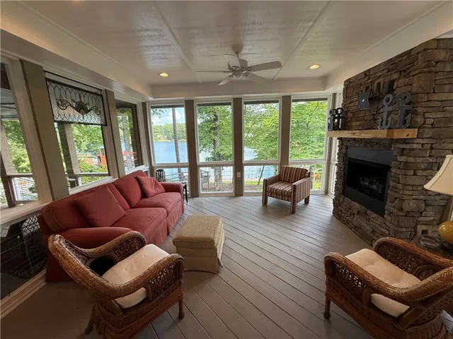 This living space offers tranquil water views and a welcoming fireplace.