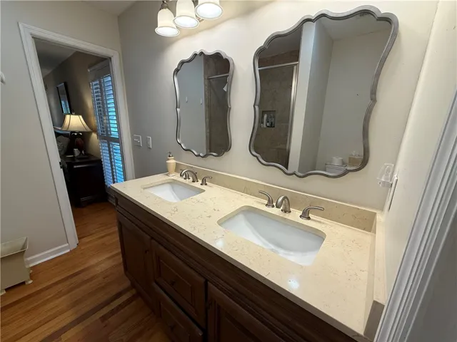 This bathroom features a double vanity and sleek countertops, providing ample space and elegant design.