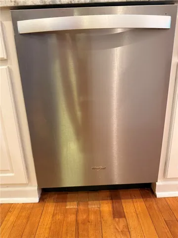 This kitchen showcases a modern stainless steel dishwasher, seamlessly integrated into the cabinetry.