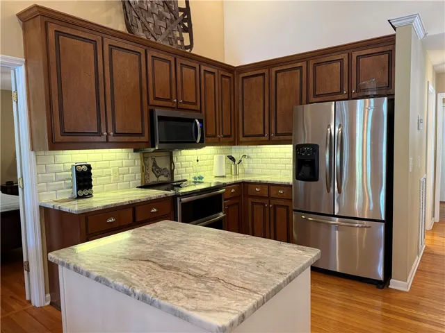 This spacious kitchen offers a large island, generous cabinetry, and contemporary appliances.