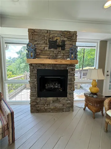 This inviting space features a captivating stone fireplace, perfect for cozy gatherings and memorable moments.