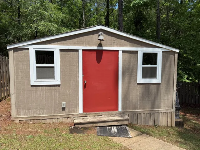 This charming utility shed offers practical outdoor storage with Air conditioning