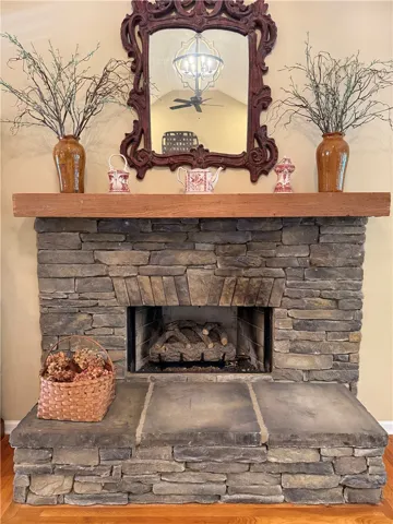 This living area features a warm stone fireplace, perfect for cozy gatherings.