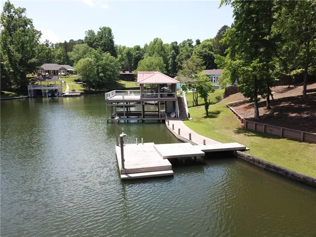 This serene waterfront property features a private dock and boathouse, perfect for lakeside living.