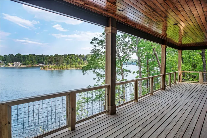 This expansive outdoor space offers sweeping water views and a tranquil forest backdrop, perfect for relaxation.