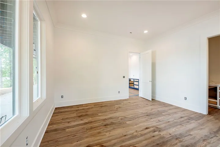 This bright space features a pristine interior with natural light and elegant crown molding.