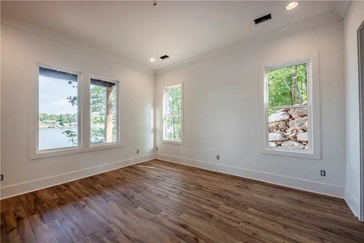Bright room with expansive views of the lake and surrounding greenery.