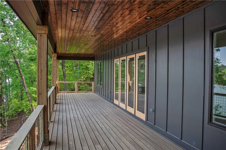 This spacious deck provides an idyllic retreat with serene woodland views.