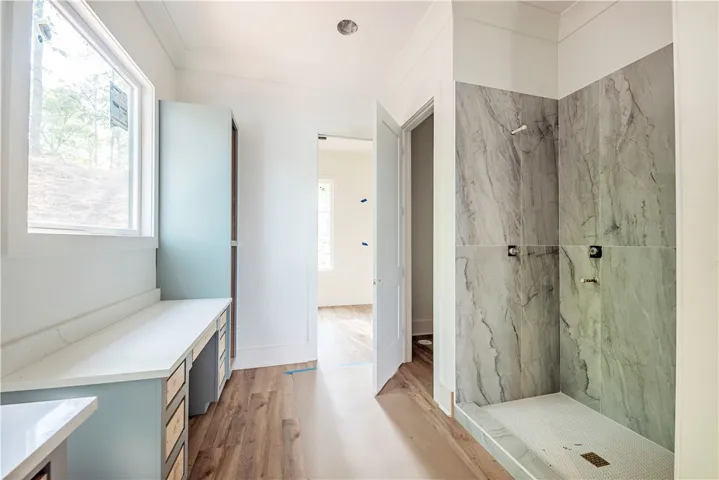 This spacious bathroom offers elegant design and a serene, functional space.