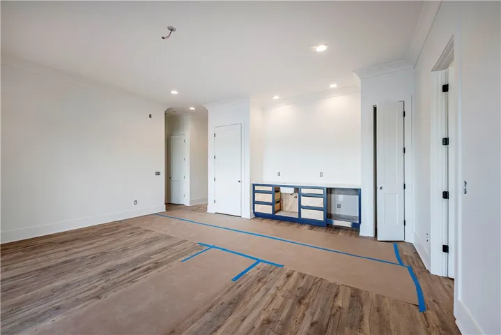 This versatile room features warm flooring, crisp walls, and thoughtful lighting, ready for your personalized touch.