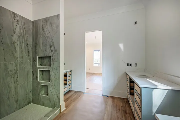 This spacious bathroom offers elegant finishes and a bright, inviting atmosphere.