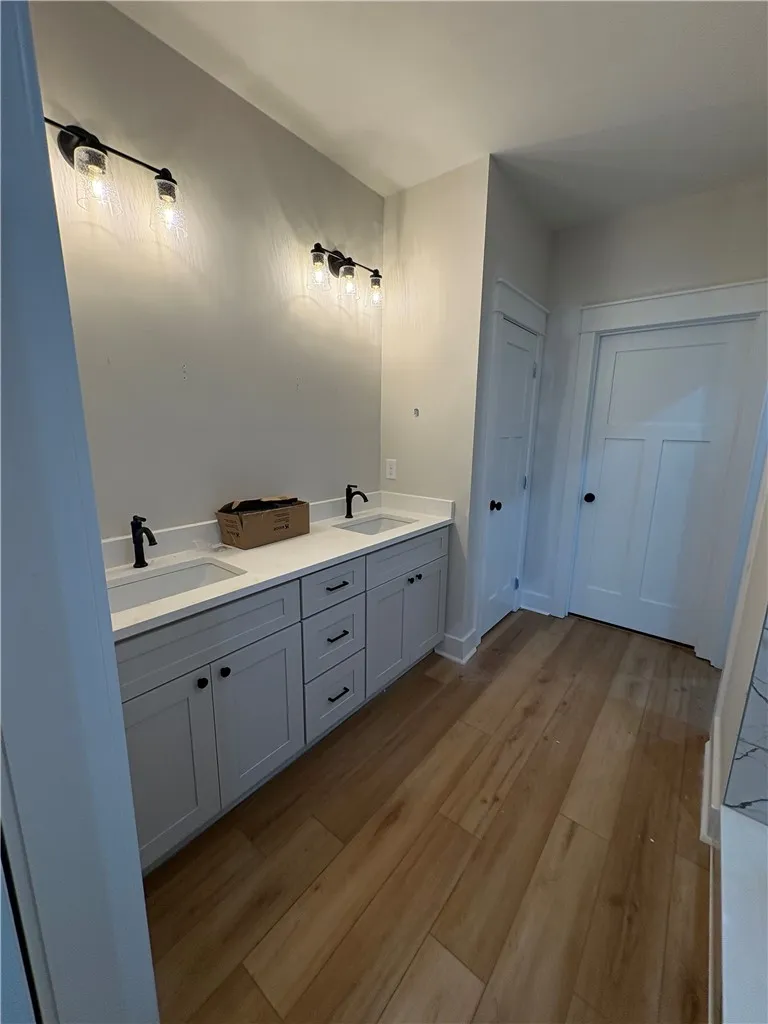 This spacious bathroom offers a double vanity and sleek hardware for a contemporary look.