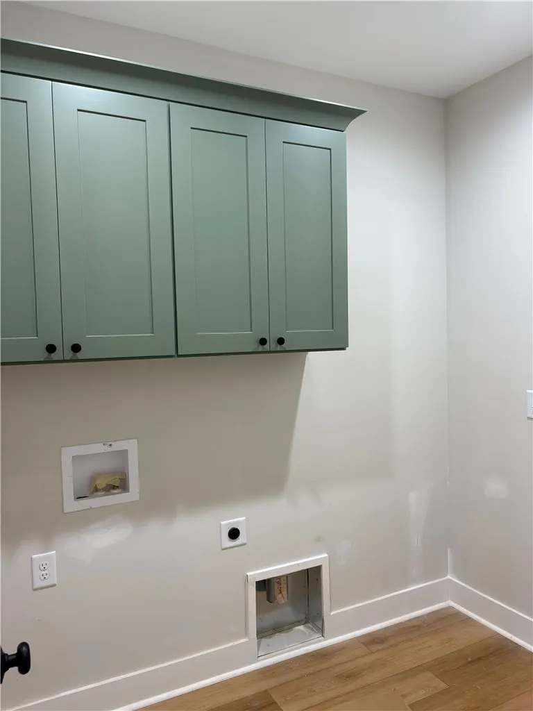 This dedicated laundry space features ample cabinetry for organized utility, ready for personal touches.