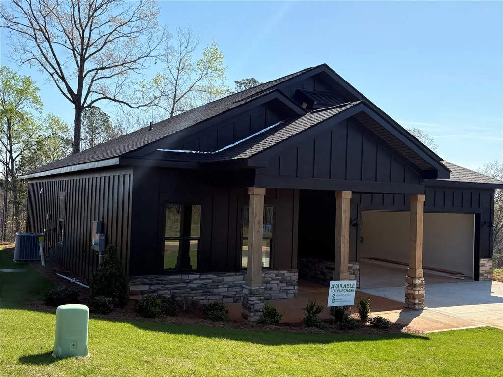 This newly constructed home features a contemporary exterior with striking architectural details and an attached garage.