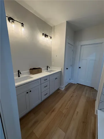 This spacious bathroom offers a double vanity and sleek hardware for a contemporary look.