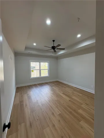 This spacious room features ample natural light and a beautiful tray ceiling.