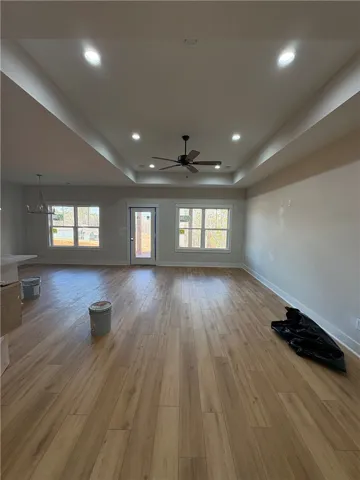 Bright and airy living space showcasing beautiful flooring and thoughtful ceiling design.