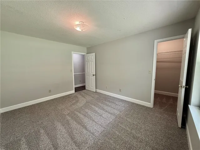 This spacious bedroom offers ample comfort and practicality.
