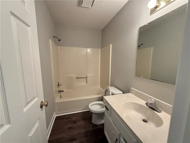 This clean and functional bathroom features practical fixtures and durable flooring.