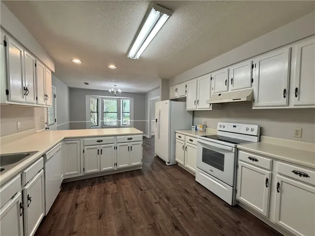 This spacious kitchen offers ample cabinetry and an inviting open floorplan to the dining area.