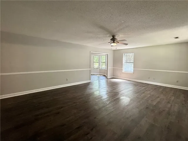 This inviting living area boasts rich hardwood floors and abundant natural light.